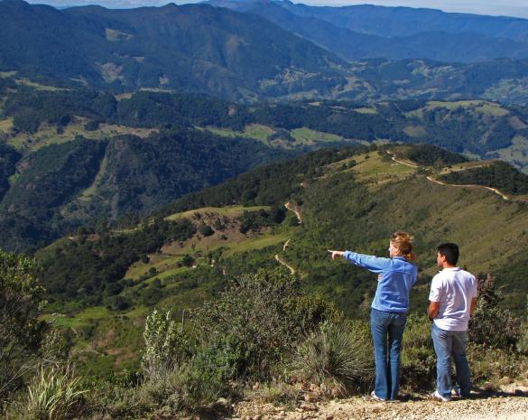NatureServe scientists look out over a patchwork landscape near Santuario de Flora y Fauna Iguaque in Santander, Colombia. Photo by Bruce Young | NatureServe