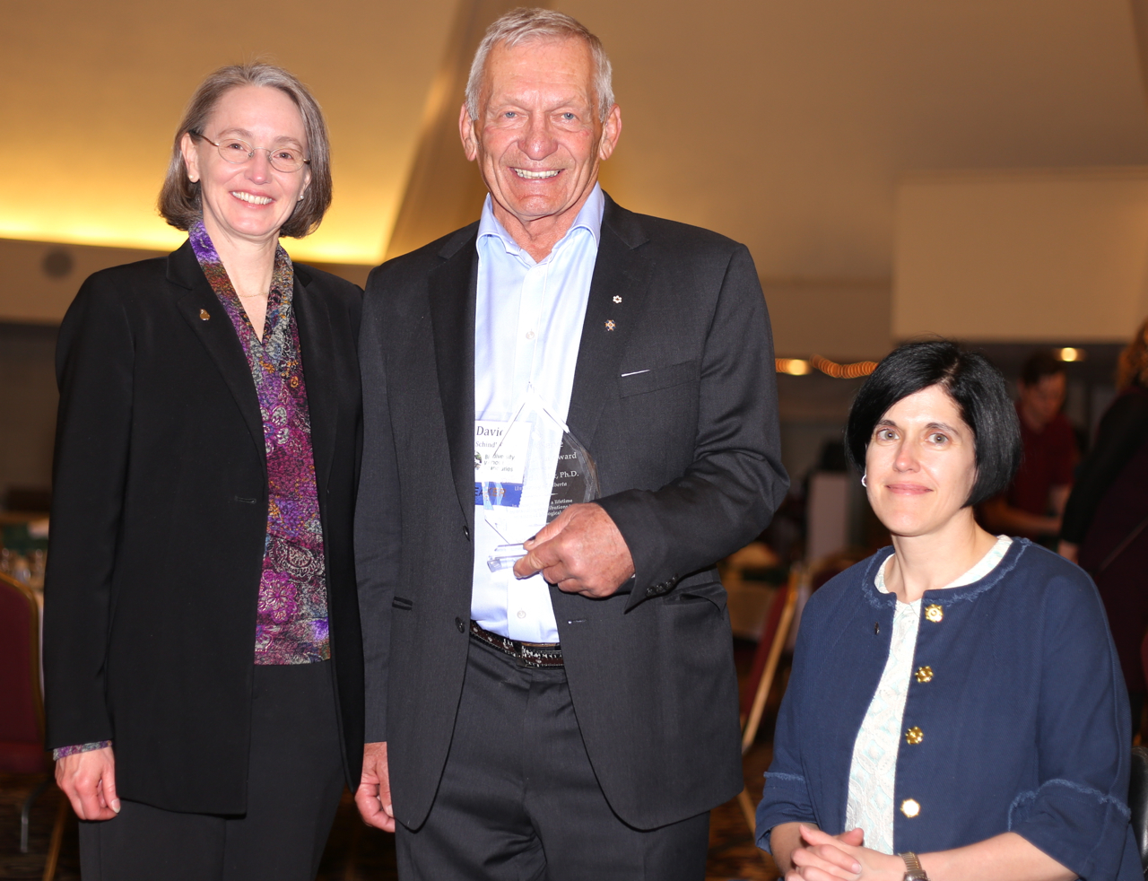 David Schindler receives the 2015 NatureServe Conservation Award from NatureServe President & CEO Mary Klein (left) and board chairwoman Nicole Firlotte (right).